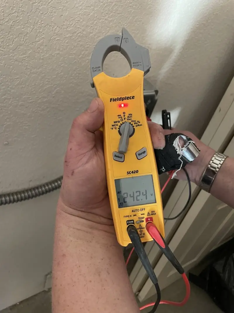 Voltage testing with clamp meter during Outlet Installation in Durango